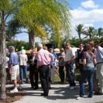 The crowd waits in line for delicious burgers and hotdogs.