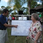Ken shows Ginny the details of the newest architectural drawings.