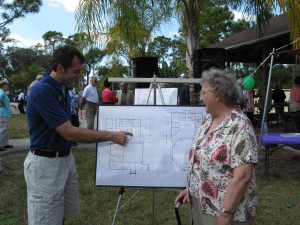 Ken shows Ginny the details of the newest architectural drawings.